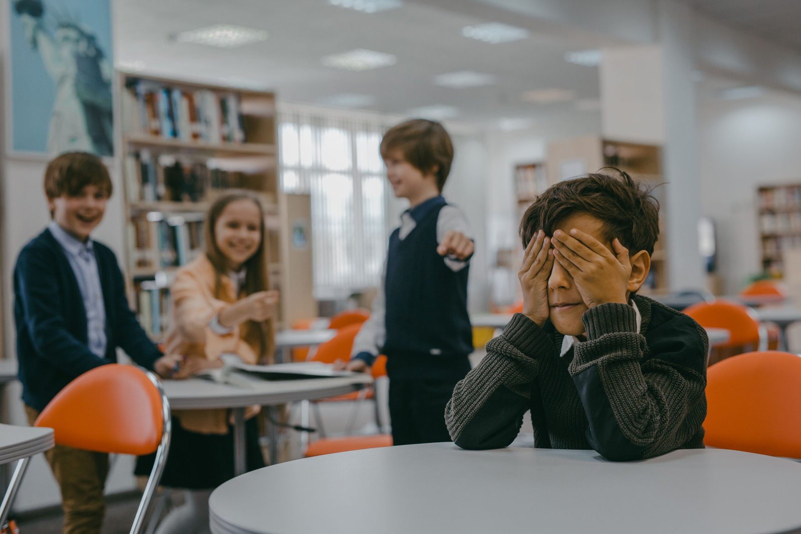 A group of children in a classroom, showing a bullying scenario.
